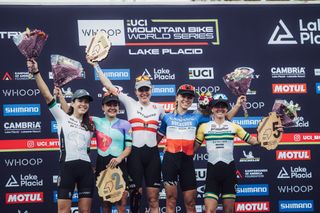 LAKE PLACID NEW YORK SEPTEMBER 29 LR fourth placed Lill Candice of Republic of South Africa second placed Sina Frei of Switzerland first placed Laura Stigger of Austria third placed Loana Lecomte of France and fifth placed Rebbeca Henderson of Australia celebrate under the podium during the UCI Mountain Bike World Cup Lake Placid Cross Country XCO Women on September 29 2024 in Lake Placid New York Photo by Piotr StaronGetty Images