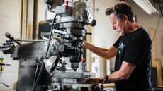 Bob parlee stands at a vertical milling machine in a workshop