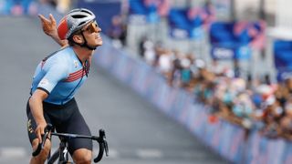 Belgium's Remco Evenepoel celebrates as he cycles to cross the finish line to win the men's cycling road race during the Paris 2024 Olympic Games in Paris, on August 3, 2024. (Photo by Odd ANDERSEN / AFP) (Photo by ODD ANDERSEN/AFP via Getty Images)