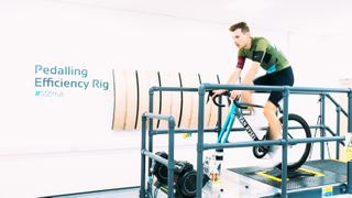 A white man on a static bike in a lab