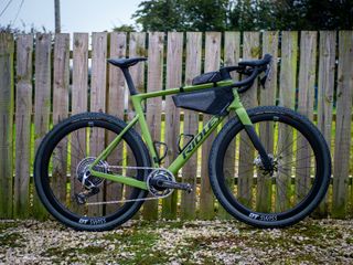 Detail photo of a green Ridley ASTR RS leaning against a wooden fence